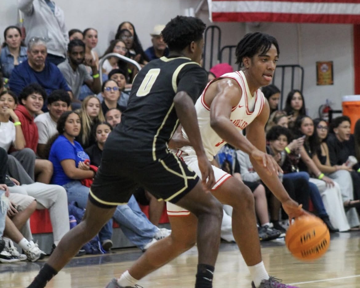 The crowd watches in awe as senior Alexander Edghill dribbles his way to the basket, avoiding the defense.