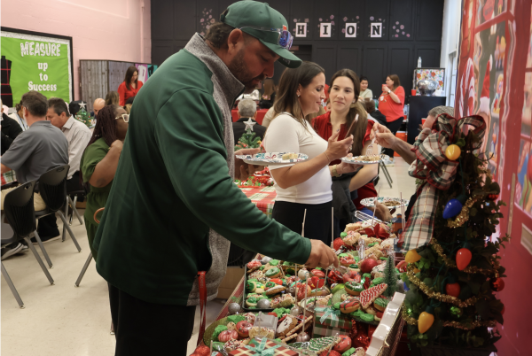 Coach Donnis chooses a treat set up by students and faculty.