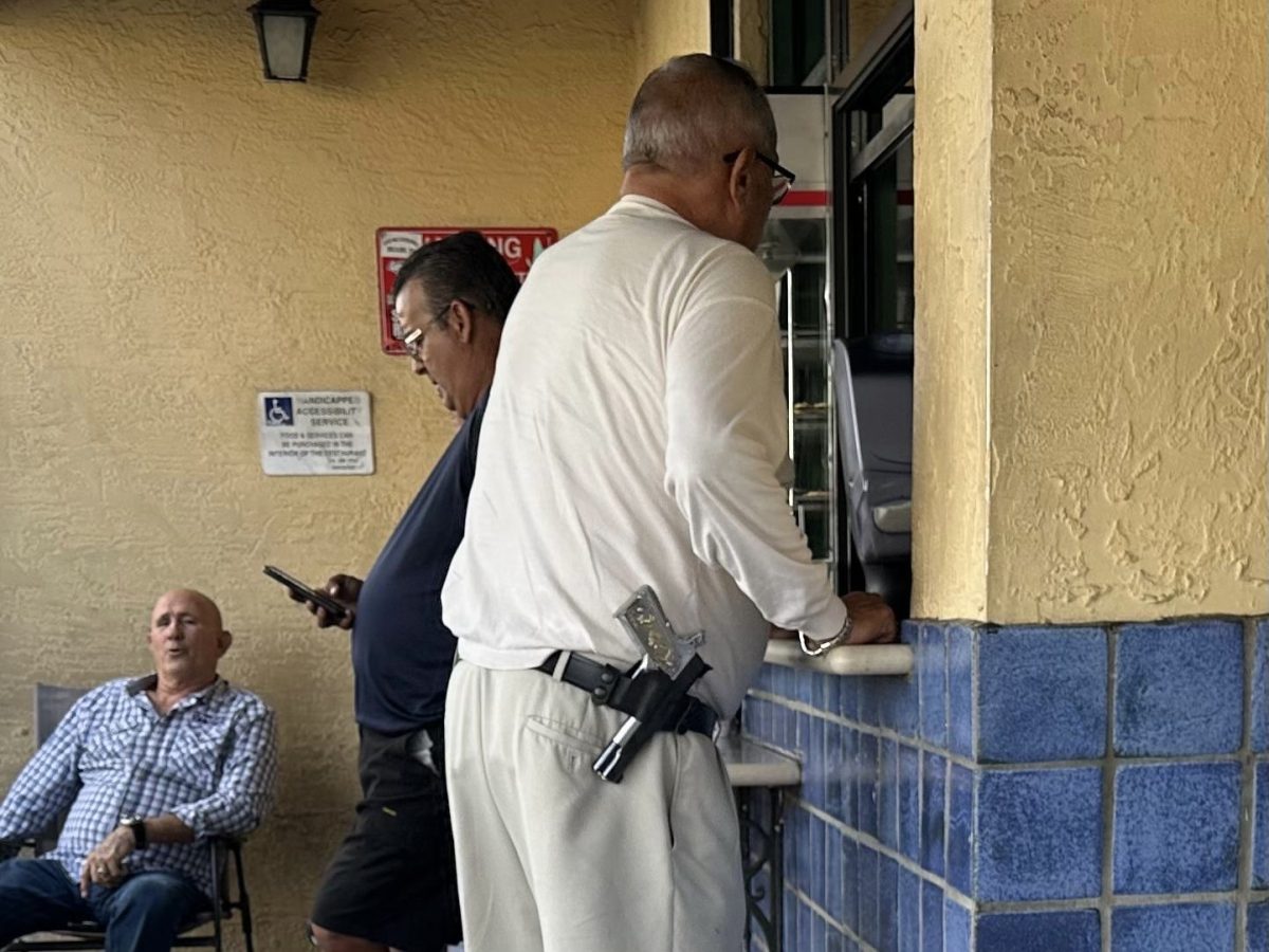 Amid a popular cafe spot in Miami, a man with an unholstered firearm gets ready to order. Unusually, there is no tension in the air: this is the new Floridian reality. 