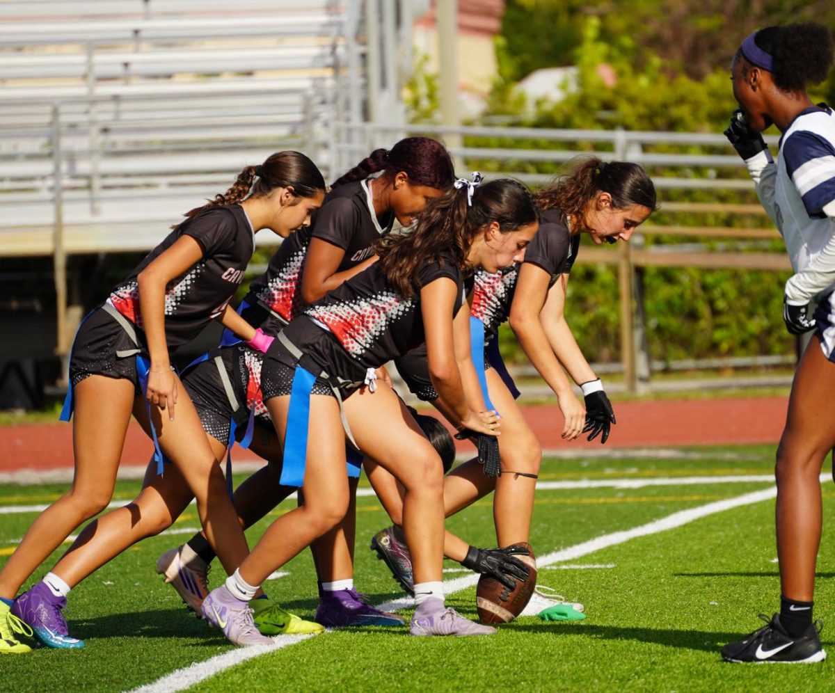 The girls varsity team lining up in a tight formation, ready to sprint into their routes. (Courtesy of Mia Daniel)