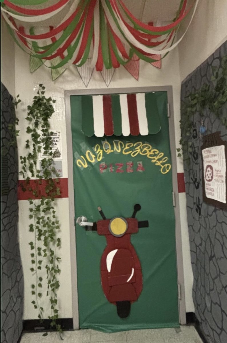 Volunteers decorated classroom doors to represent their assigned countries and earn points throughout the week. Italy's door featured a Vespa and vines designed to reflect elements of Italian culture.